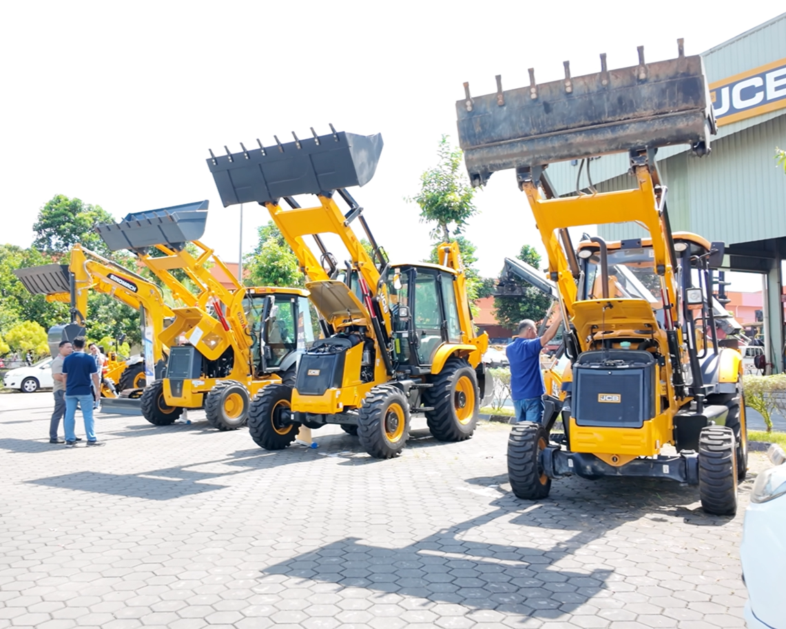 Road construction site with heavy machinery grading the ground.